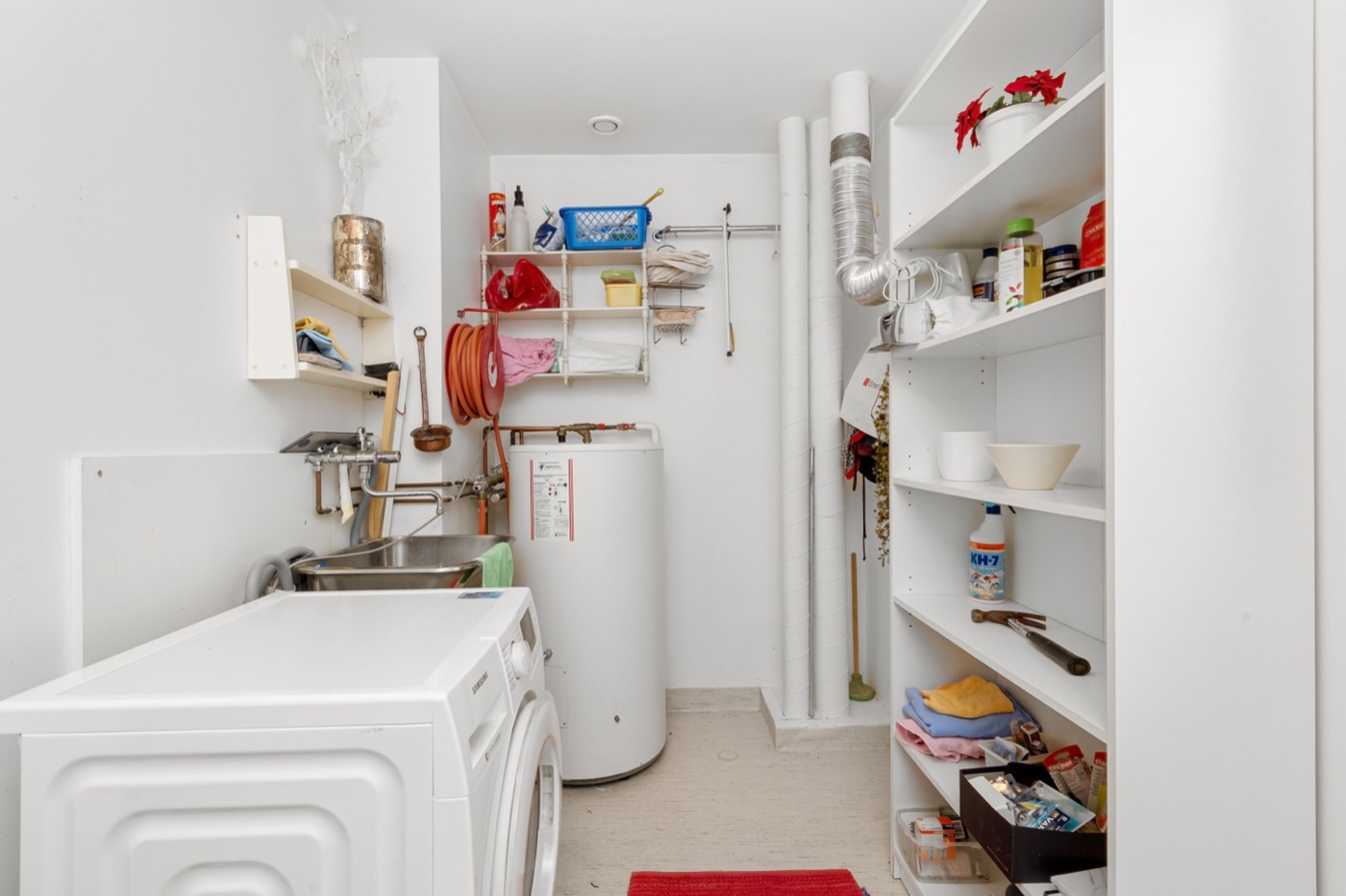 Water heater tank in a home laundry and utility room in a family home in Abbotsford, BC